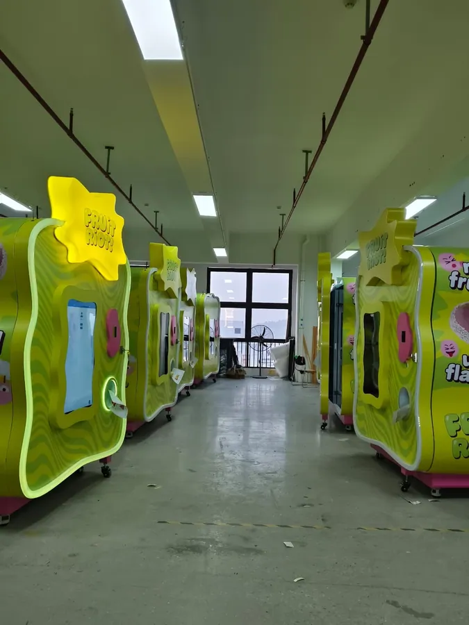 A line of custom Fruit Riot machines being built at the Sweet Robo factory